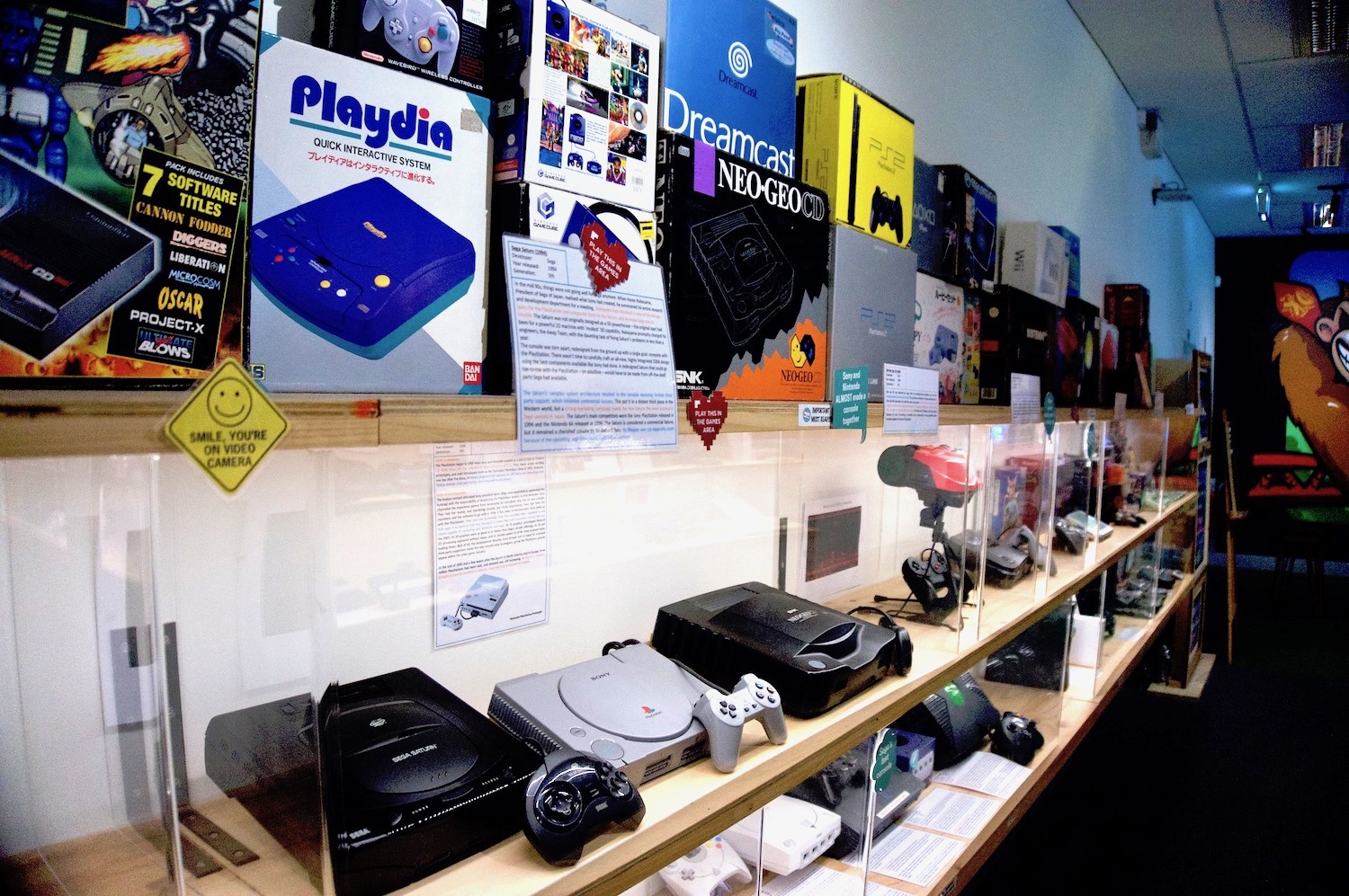 Photo from The Nostalgia Box museum, showing boxes for the Playdia and Dreamcast, among others, as well as the Saturn, PS1, and other consoles.
