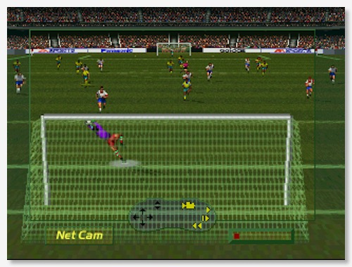 A screenshot of FIFA International Soccer for 3DO, showing a goalkeeper making a diving save. The camera is positioned behind the goal, pointing straight towards the other end of the field. All 22 players are visible.