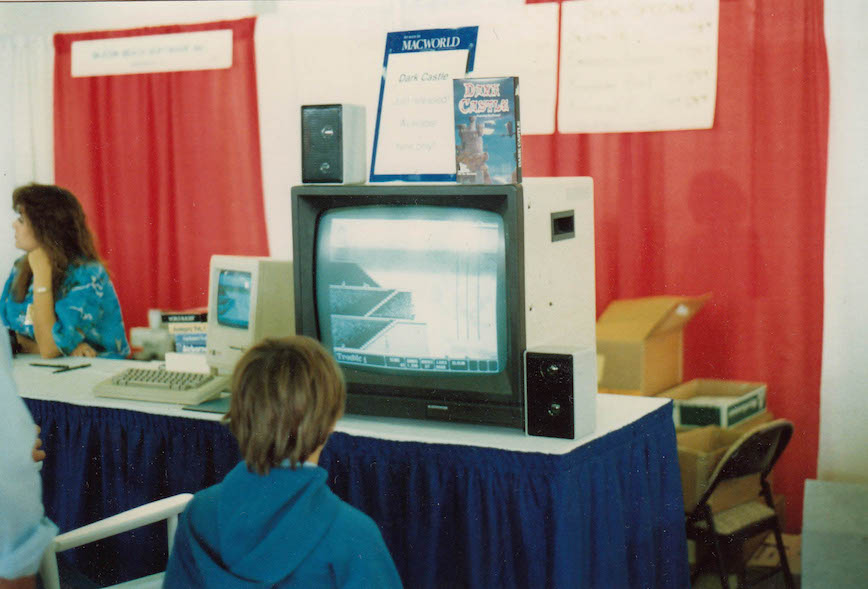 A young boy watches Dark Castle in demo/autoplay mode at Macworld Expo in Dallas 1986.